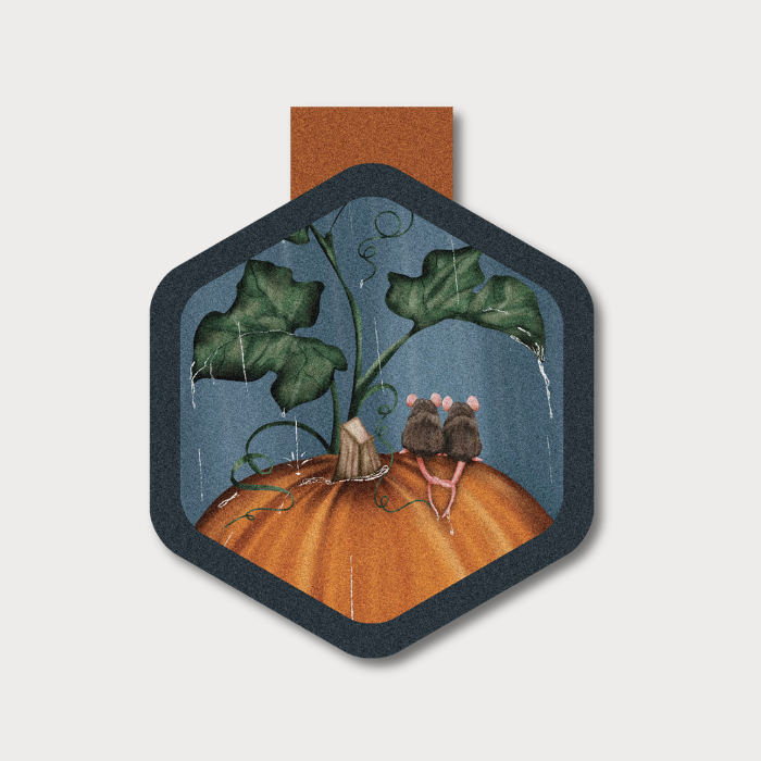 A picture of two cute mice sitting on an orange pumpkin in the rain on a hexagon shaped magnetic bookmark